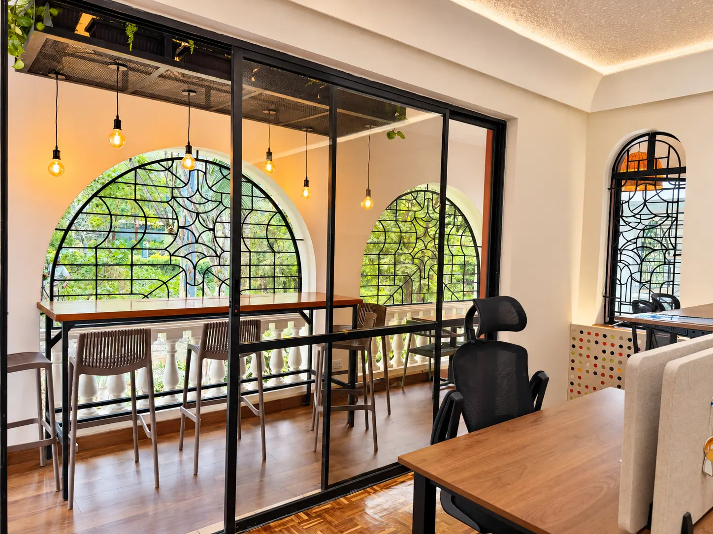 View from the studio floor through glazed doors to the arched garden terrace